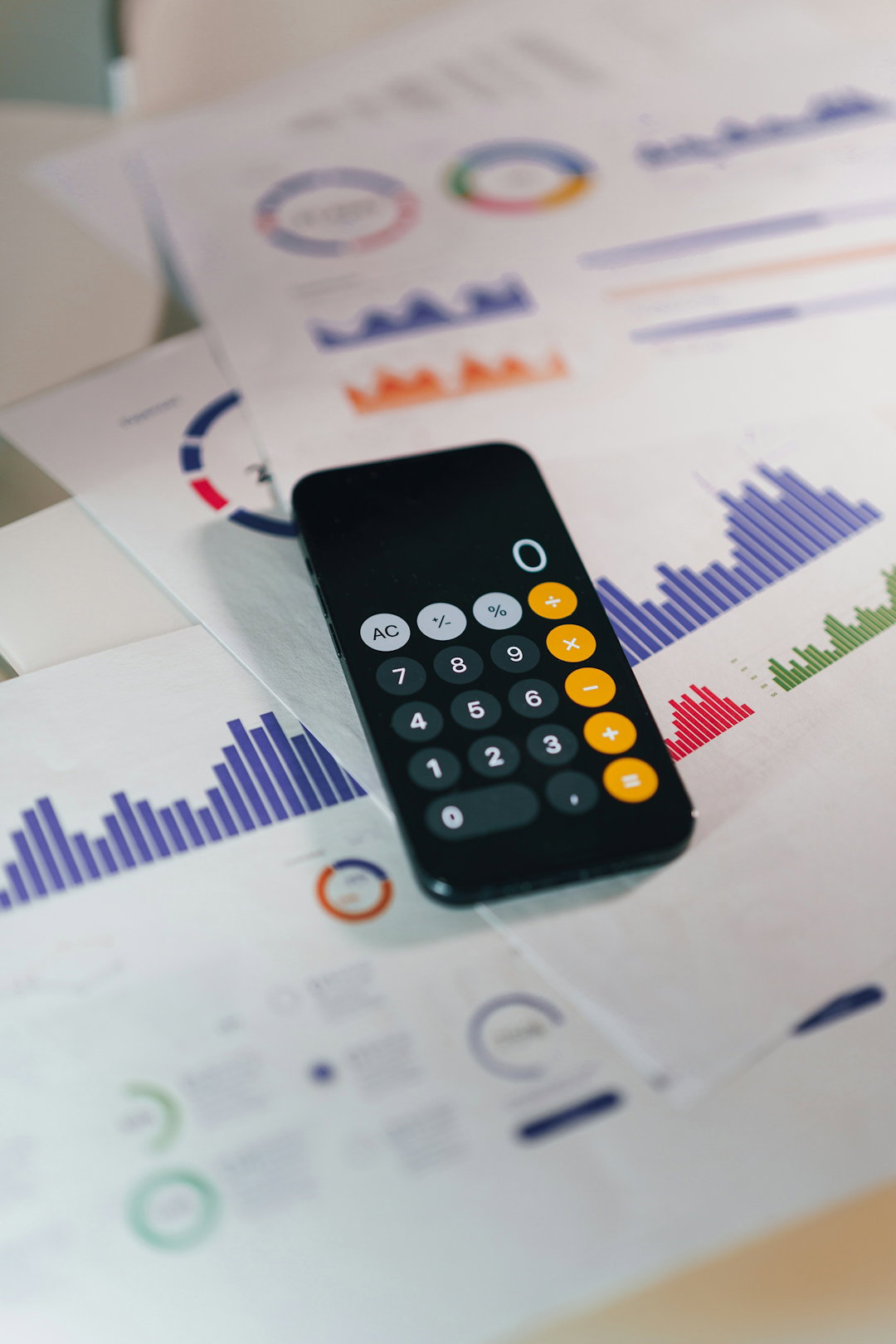 smartphone-calculator-app-on-financial-report-papers.jpg smartphone calculator app on financial report papers